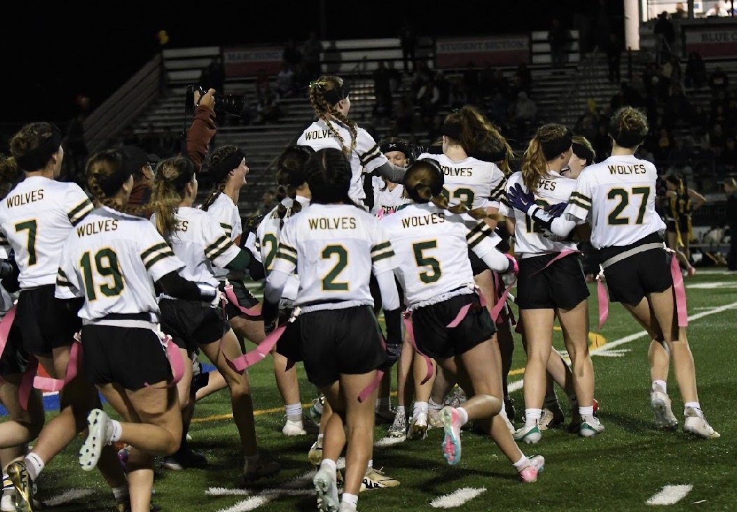 SRVHS Wolves girls flag football team celebrating on the field after a win